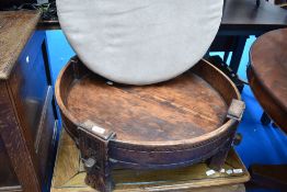 An Indian style Chakki table , having additional upholstered suede cushion, diameter approx. 75cm