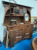 An Arts and Crafts oak dresser, with planished style metal handles and Art Nouveau inlay decoration,