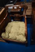 A 19th Century mahogany carved chair having shaped rail back and scroll arms
