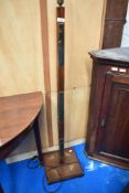 An early to mid 20th Century mahogany standard lamp , having brass decoration