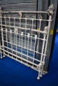 A Victorian cast metal bed frame with brass detailing, approx width 135cm