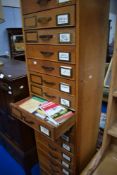 A large vintage filing drawer system containing maps and guidebooks etc, categorised into areas