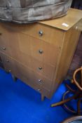A vintage ply bedroom chest of five long drawers