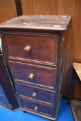A dark stained pine tall chest of four drawers, height approx. 122cm