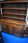 An 18th Century and later oak dresser with delft rack, width approx. 151cm