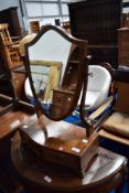 An early 20th Century walnut toilet mirror having drawer base