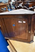 A traditional small oak corner cabinet, height approx. 45cm
