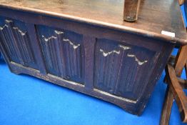 An early 20th Century bedding box having linen fold decoration, width approx. 84cm