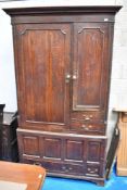 An 18th Century oak linen press having pannelled doors and brass drop handles