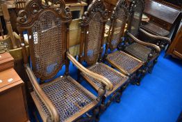 A set of four (two plus two) oak Carolean style chairs having cane seats and back panels