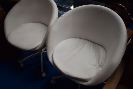 Two vintage style white vinyl swivel chairs