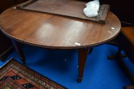 A late 19th or early 20th Century oval windout dining table of oval form on square tapered legs with