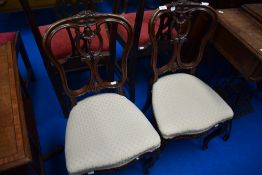 A pair of Edwardian mahogany salon chairs