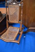A 19th Century campaign style folding chair having bergere seat and back panel