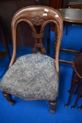 A Victorian mahogany nursing chair of interesting design with strap style turned design ,