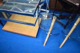 A vintage chrome and glass TV or computer table and two modern stylised occasional tables