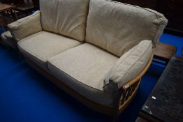 A modern Ercol settee and footstool