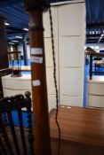 An early 20th Century flame mahogany standard lamp
