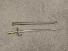 A French Sword Bayonet for the Chassepot Rifle 1866, blade edge etched 1873, brass grip, metal
