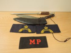 A Kukri Knife with leather Scabbard, blade length 31cm, overall length 40cm along with a knife