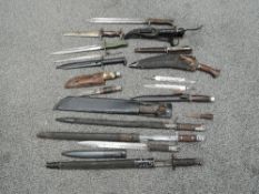 A collection of British, German and World Bayonets and Knives, mainly reproduction or made up, one