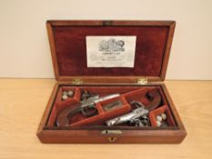 A pair of 19th century J Bunney & Son London Duelling Flintlock Pistols having turn off barrels,