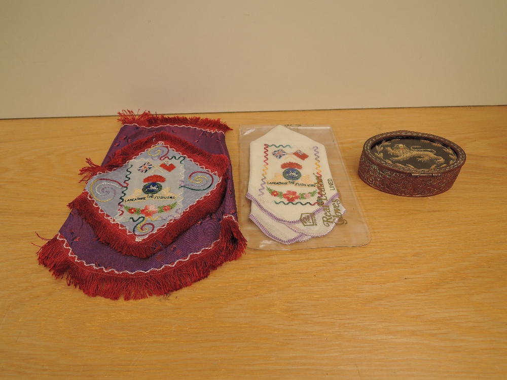A metal decorated oval box with Kings Own embroidered Lion on lid along with two Lancashire