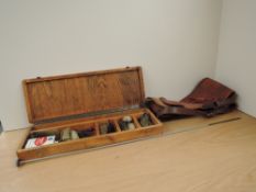 A Gun Cleaning Kit for a Rifle or a Shotgun in a fitted wooden case with a canvas and leather gun