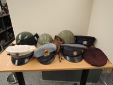 A collection of Military Caps and Helmets including South Africa Police Equestrian Helmet, South