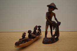 A carved Indian study of a gent in primitive attire and a carved wooden boat with African figures.