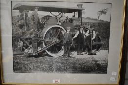 A vintage photographic print of a steam road roller with four crew. Framed and glazed 67cm x 54cm.