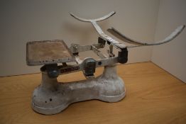 A set of vintage English white painted balance scales, marked To Weigh 28LB, lacking pan and