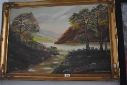 A painting of a path leading to a lake signed Margaret Woodward measuring 60cm x 70cm