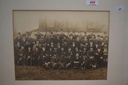 A mounted photographic print of a group of 19th Century men