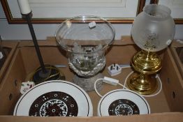 A grey stone candle holder/storm lamp, an brass style oil lamp electric table lamp, a similar