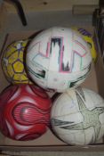 Five assorted design footballs.