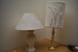 Two modern table lamps, one a ceramic hexagonal base and the other a brass candlestick style