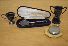 A cased pair of yellow metal lorgnettes, two silver plated miniature trophies, the largest measuring