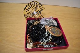 An assortment of costume jewellery, including brooches, beaded jewellery, a large hair comb etc