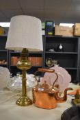 A 19th Century copper fireside kettle, measuring 27cm high, and a brass oil lamp form table lamp