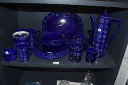 An assorted collection of mid-20th Century Portmeirion Totem patterned tableware against a blue