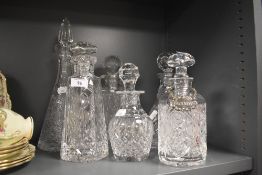 A selection of 20th Century cut glass decanters, one bearing a silver plated 'Brandy' decanter