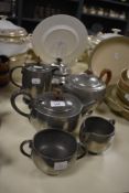 An Arts and Crafts Tudric Pewter teapot, measuring 16cm high, and a selection of other pewter ware