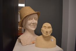 A large plaster bust of a smiling lady, measuring 35cm high, and another bust