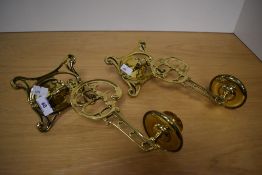 A pair of 19th Century brass hinged candelabra wall fittings, measuring 26cm long each