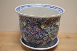 A Chinese pottery jardinière and stand, decorated in polychrome with fruits, blossoms and birds 17cm