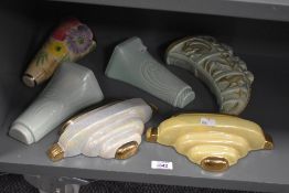 Six assorted wall pockets including a Burleigh Ware tiger's claw design having raised squirrel, deer
