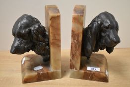 A pair of Art Deco bookends, modelled as spelter spaniel dog heads signed 'Lecourtier' on angled