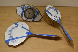 An Art Deco three piece guilloche enamelled dressing table set, comprising mirror, brush, and mantel