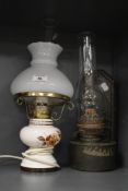 A mid-20th Century electrified table lamp in the form of an oil lamp, measuring 40cm high, and a tin